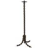 A STANDARD LAMP MADE FROM A LARGE CHAIN.