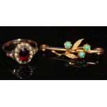 A VICTORIAN 9CT GOLD, GARNET AND SEED PEARL RING Having an oval cut garnet with a single row of seed