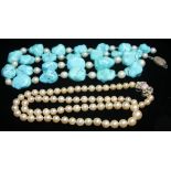 A SINGLE ROW PEARL NECKLACE of 5.9-8.8mm pearls with a 14ct white gold diamond and opal-set bow-