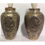 A PAIR OF ANTIQUE PERSIAN SILVER OVOID VASES With finely chased floral designs held in oval