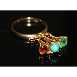 AN 18CT GOLD, TURQUOISE, EMERALD AND AMETHYST RING The stones suspended on ropetwist wires and set