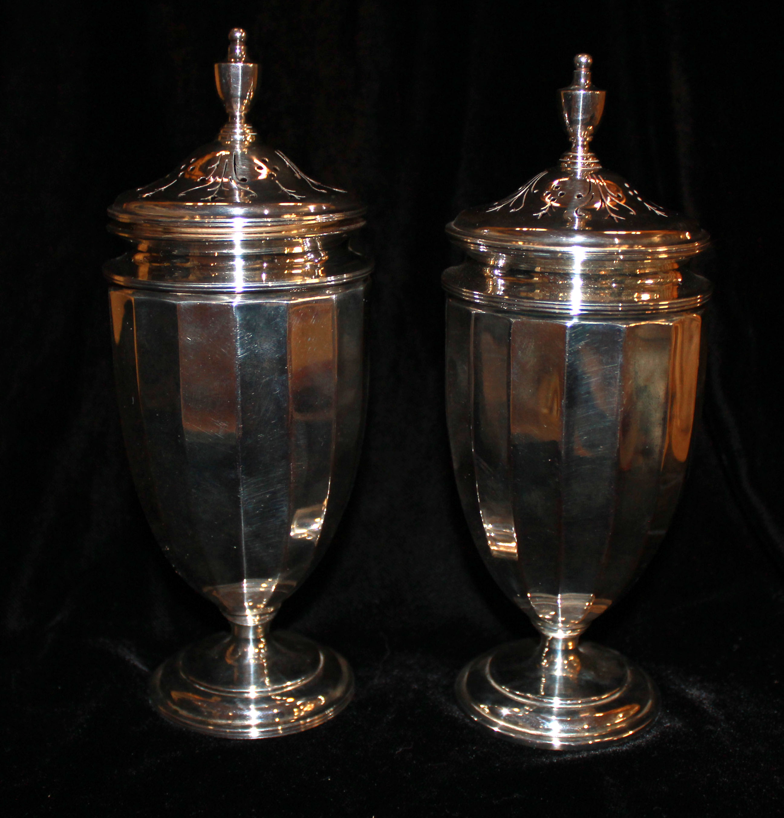 A CASED PAIR OF VINTAGE NEOCLASSICAL STYLE SILVER SUGAR CASTERS Having an urn shape finial and