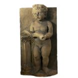 ARCHITECTURAL INTEREST, A CAST STONE FRIEZE OF A CLASSICAL STYLE PUTTI CASTED IN RELIEF Reading a