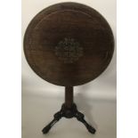 A REGENCY ROSEWOOD AND BRASS INLAID SNAP TOP OCCASIONAL TABLE Raised on pedestal base terminating on