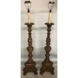 A PAIR OF 18TH CENTURY ITALIAN DESIGN CARVED GILTWOOD TORCHES CONVERTED TO LAMPS The circular tops