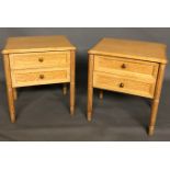 A PAIR OF LIMED OAK BEDSIDE CABINETS With two drawers, raised on turned and fluted legs. (49cm x