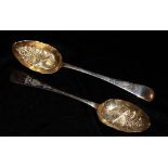 A PAIR OF EARLY 20TH CENTURY SILVER BERRY SPOONS The gilt bowls embossed with birds and flowers,