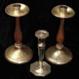 A PAIR OF EARLY 20TH CENTURY SILVER AND TURNED OAK CANDLESTICKS Having a plain circular drip pan set