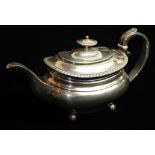 A GEORGIAN SILVER SQUAT FORM TEAPOT With gadrooned border and acanthus leaf to handle. hallmarked