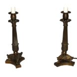 A PAIR OF 20TH CENTURY BRASS EMPIRE STYLE LAMPS Having acanthus leaf drip pans and reeded columns,