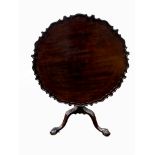 A GEORGE III PERIOD MAHOGANY TILT TOP TEA TABLE The circular piecrust top with birdcage, raised on a