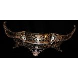 AN EARLY 20TH CENTURY SILVER LOBBED CAKE BASKET Having a scalloped edge set with shells and scrolls,