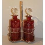 A PAIR OF 20TH CENTURY BOHEMIAN GLASS DECANTERS Two ruby glass cylindrical decanters having