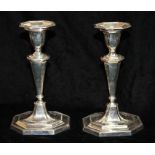 A PAIR OF EDWARDIAN SILVER NEOCLASSICAL CANDLESTICKS With reeded sides and octagonal base,