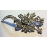 A VINTAGE PLATINUM AND DIAMOND BROOCH The arrangement of round and baguette cut diamonds forming a