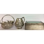 AN EARLY 20TH CENTURY INDIAN SILVER SUGAR BASKET AND CREAM JUG Having a swing handle and embossed