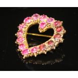 A 19TH CENTURY RUBY HEART BROOCH Of yellow metal and open form, set throughout with circular cut