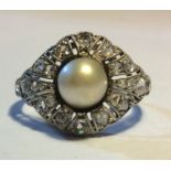 AN EARLY 20TH CENTURY WHITE METAL, DIAMOND AND PEARL SET RING Having a single pearl surrounded