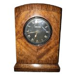 JAEGER, AN EARLY 20TH CENTURY CHROME AND WALNUT CAR CLOCK Having a circular black dial with white