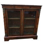 A VICTORIAN WALNUT CABINET The satin inlaid frieze with foliate scroll motifs over gilt metal