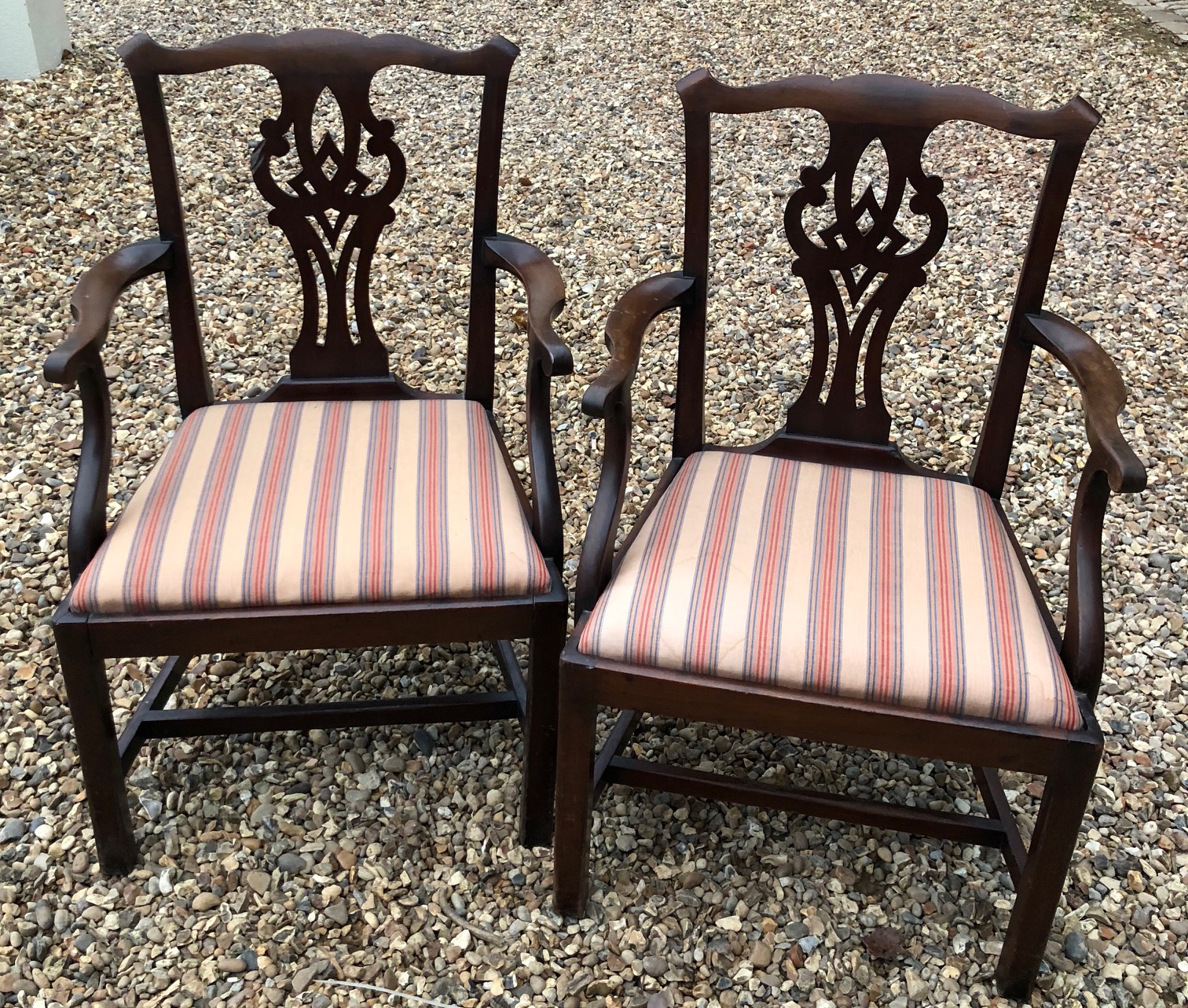 A PAIR OF 18TH CENTURY DESIGN MAHOGANY OPEN ARMCHAIRS Having pierced vase splatbacks and upholstered
