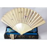 AN IVORY AND EMBROIDERED SILK FOLDING FAN, CIRCA 1900 Uncarved, the silk panels embroidered with