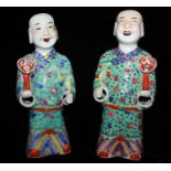 A PAIR OF FAMILLE ROSE FIGURES OF LAUGHING BOYS, CIRCA 1920 Each standing in turquoise robes,