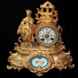 A 19TH CENTURY FRENCH SPELTER AND PORCELAIN FIGURAL MANTLE CLOCK Cast with a maiden holding a
