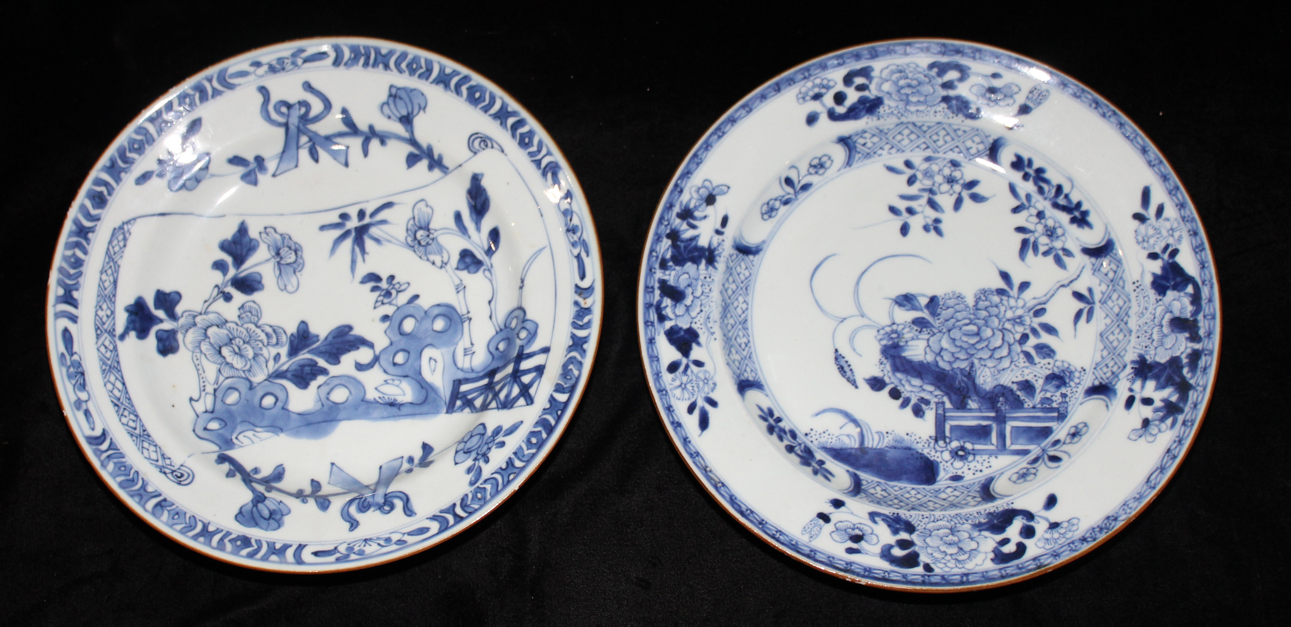 TWO 18TH CENTURY CHINESE EXPORT PORCELAIN BLUE AND WHITE PLATES Hand painted with a floral garden