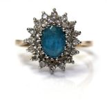 A VINTAGE 9CT GOLD, AQUAMARINE AND DIAMOND CLUSTER RING Having an oval cut aquamarine stone