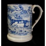 AN EARLY 19TH CENTURY BLUE AND WHITE POTTERY TANKARD Moulded in relief and having a transfer print