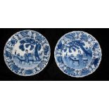 A PAIR OF KANGXI BLUE AND WHITE PLATES Decorated with garden scenes with female figures on daybeds