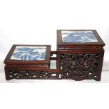 A 19TH CENTURY TWO TIER WOODEN STAND Inset with two blue and white panels of landscapes, the pierced