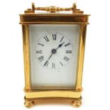 A 20TH CENTURY GILT BRASS CARRIAGE CLOCK Having a curved rectangular case and four bevelled glass