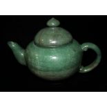 A SPINACH GREEN JADE TEAPOT AND COVER Of plain rounded form. (7")