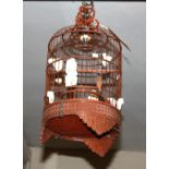 AN EARLY 20TH CENTURY CHINESE CARVED WOODEN CYLNDRICAL BIRDCAGE Set with carved ivory panels, the