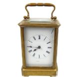 A 20TH CENTURY GILT BRASS CARRIAGE CLOCK With four glass panels and visual platform escapement