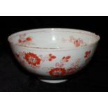 AN ANTIQUE ORIENTAL PORCELAIN BOWL Hand painted with floral decoration on a red ground, bearing an