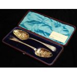 A PAIR OF GEORGIAN SILVER BERRY SPOONS Having engraved decoration to handles, the gilt bowls