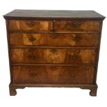 AN EARLY 18TH CENTURY WALNUT AND OAK CHEST Of two short above three long drawers, raised on