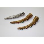 THREE DECORATIVE FINGERNAIL GUARDS, CIRCA 1900 To include one silver and two silver gilt.