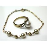 A VINTAGE 14CT GOLD AND PEARL SET BRACELET Three pearls interspersed with spherical gold spacers and