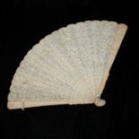 AN IVORY AND EMBROIDERED SILK FOLDING FAN, CIRCA 1860 Carved both on guards and brisé panels, with