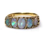 A VINTAGE 18CT GOLD, OPAL AND DIAMOND FIVE STONE RING Set with graduating cabochon cut opals each