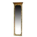 A 19TH CENTURY PIER MIRROR The giltwood cornice above a distressed painted frame and silvered plate.