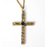 A VINTAGE YELLOW METAL, DIAMOND AND SAPPHIRE CRUCIFIX PENDANT The single round cut sapphire