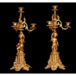 A PAIR OF 19TH CENTURY GILT BRONZE CANDELABRA The five branches held aloft by putti. (44cm)