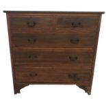 AN EDWARDIAN MAHOGANY AND SATINWOOD CROSSBANDED CHEST Of two over three long drawers, raised on