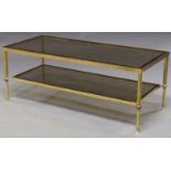 MANNER OF MAISON JANSEN, A 20TH CENTURY FRENCH TWO TIER BRAS AND SMOKED GLASS COFFEE TABLE Raised on