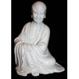 A BLANC DE CHINE SEATED FIGURE OF BEARDED LOHAN Well carved, with robes and bare chest, bearing seal